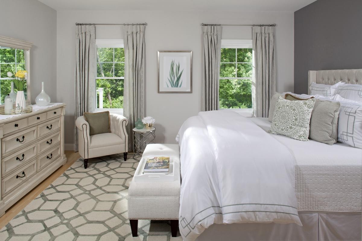 Primary bedroom in soft whites