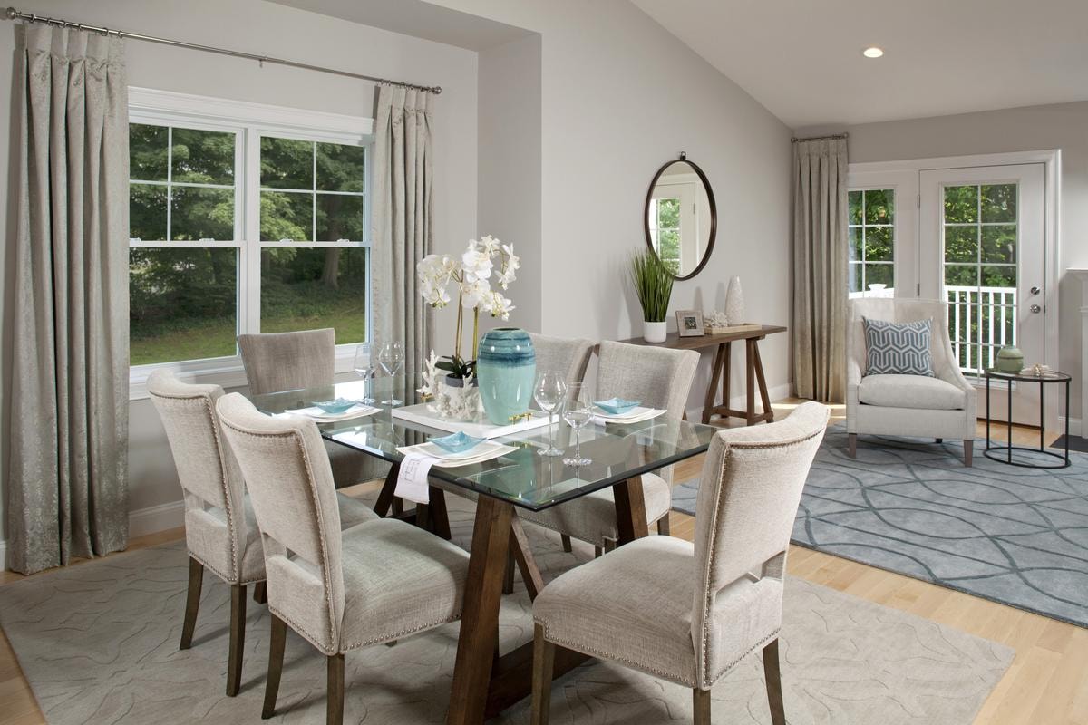 Dining area with glass table and vaulted ceiling
