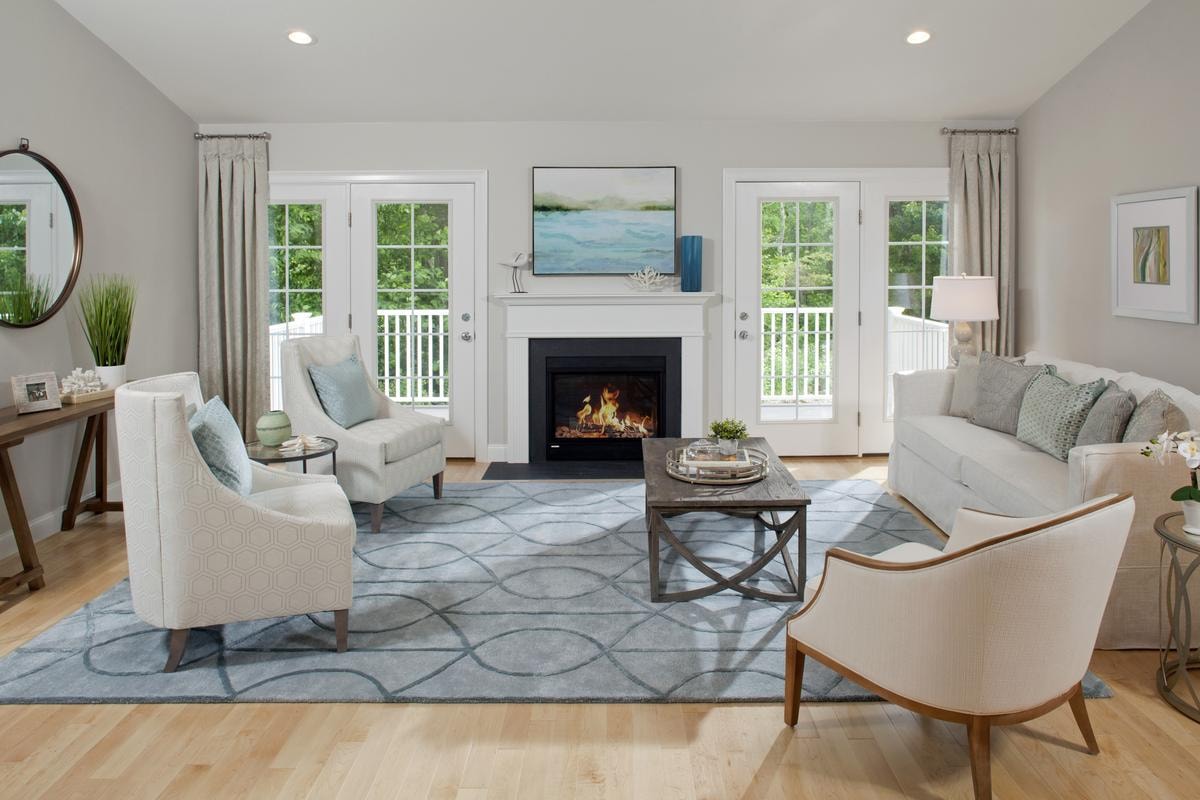 Townhome living room with fireplace and French doors to the deck